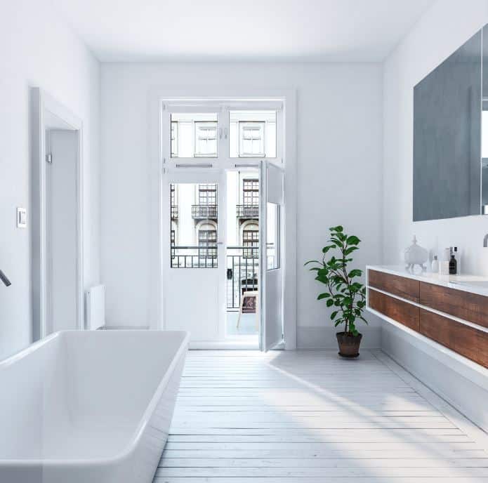 man holding hose at top of water heater