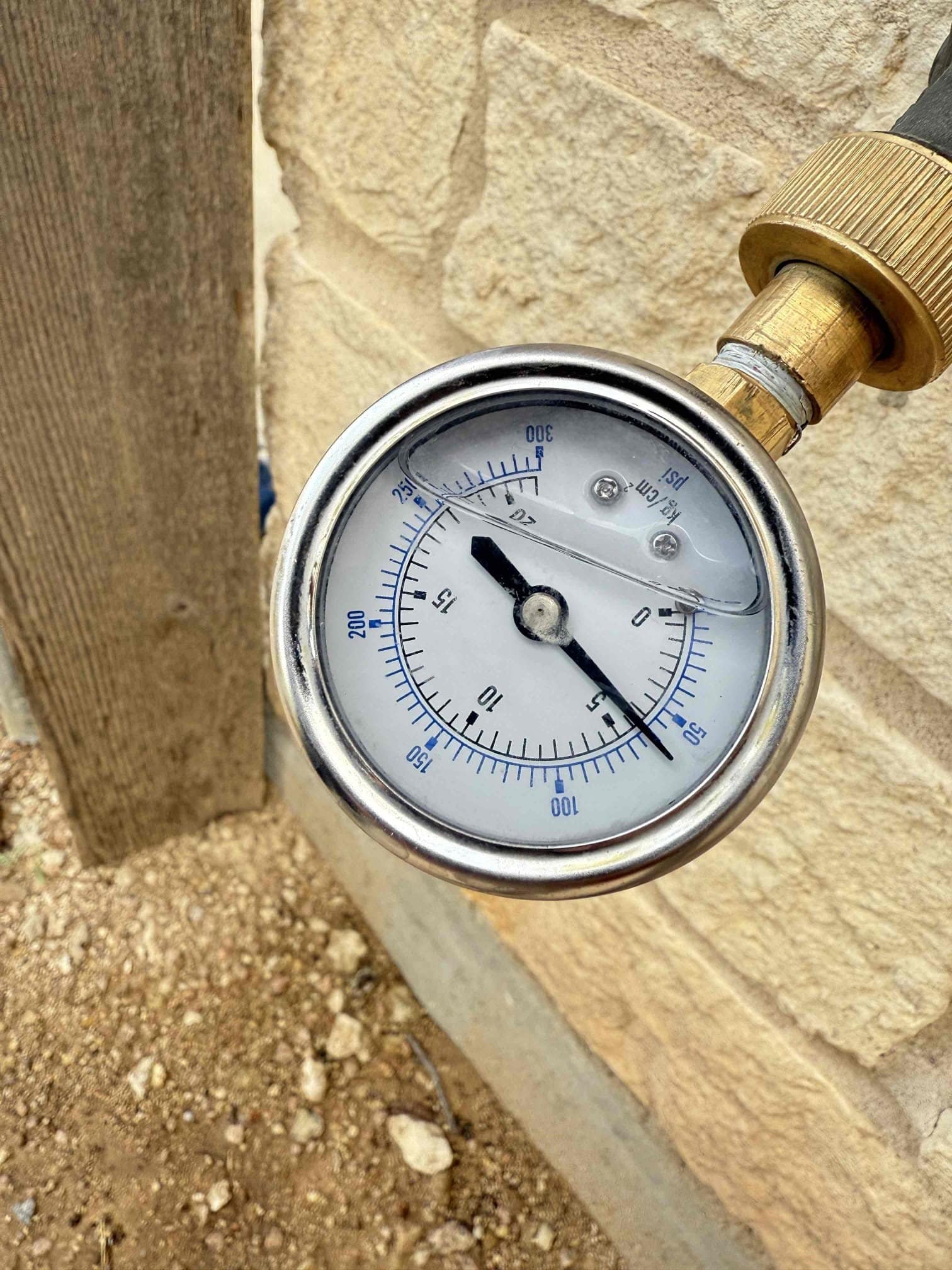 man holding hose at top of water heater