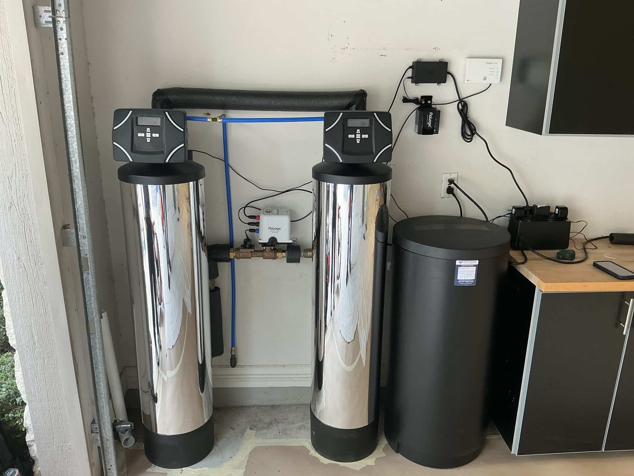 man holding hose at top of water heater