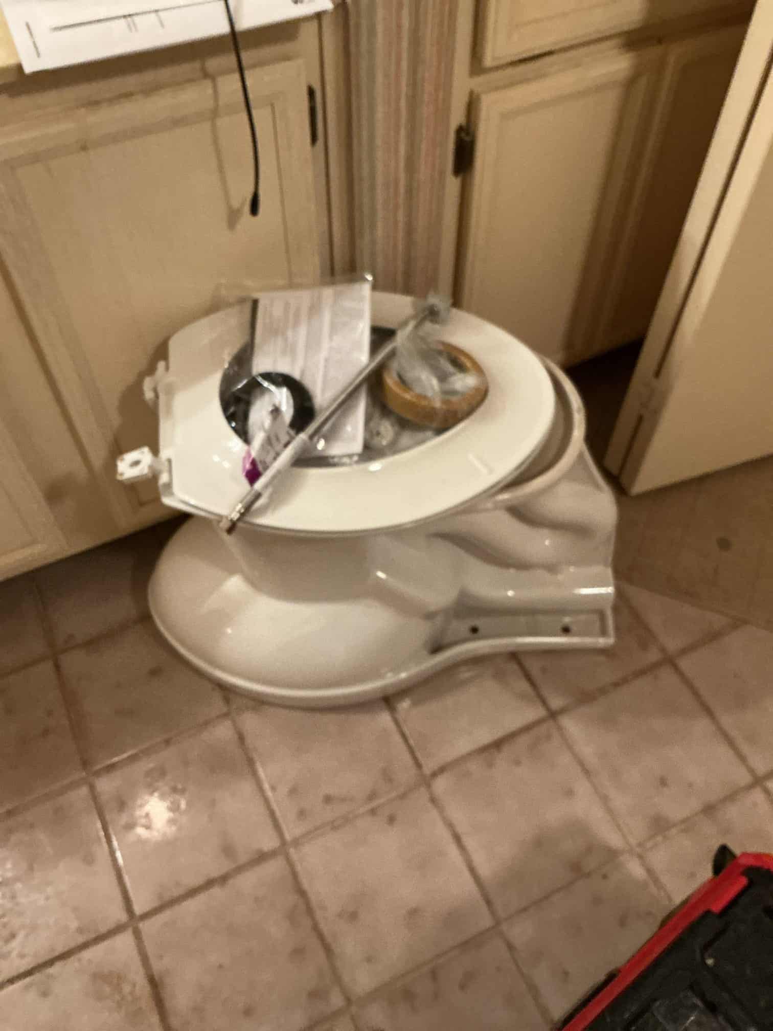 man holding hose at top of water heater